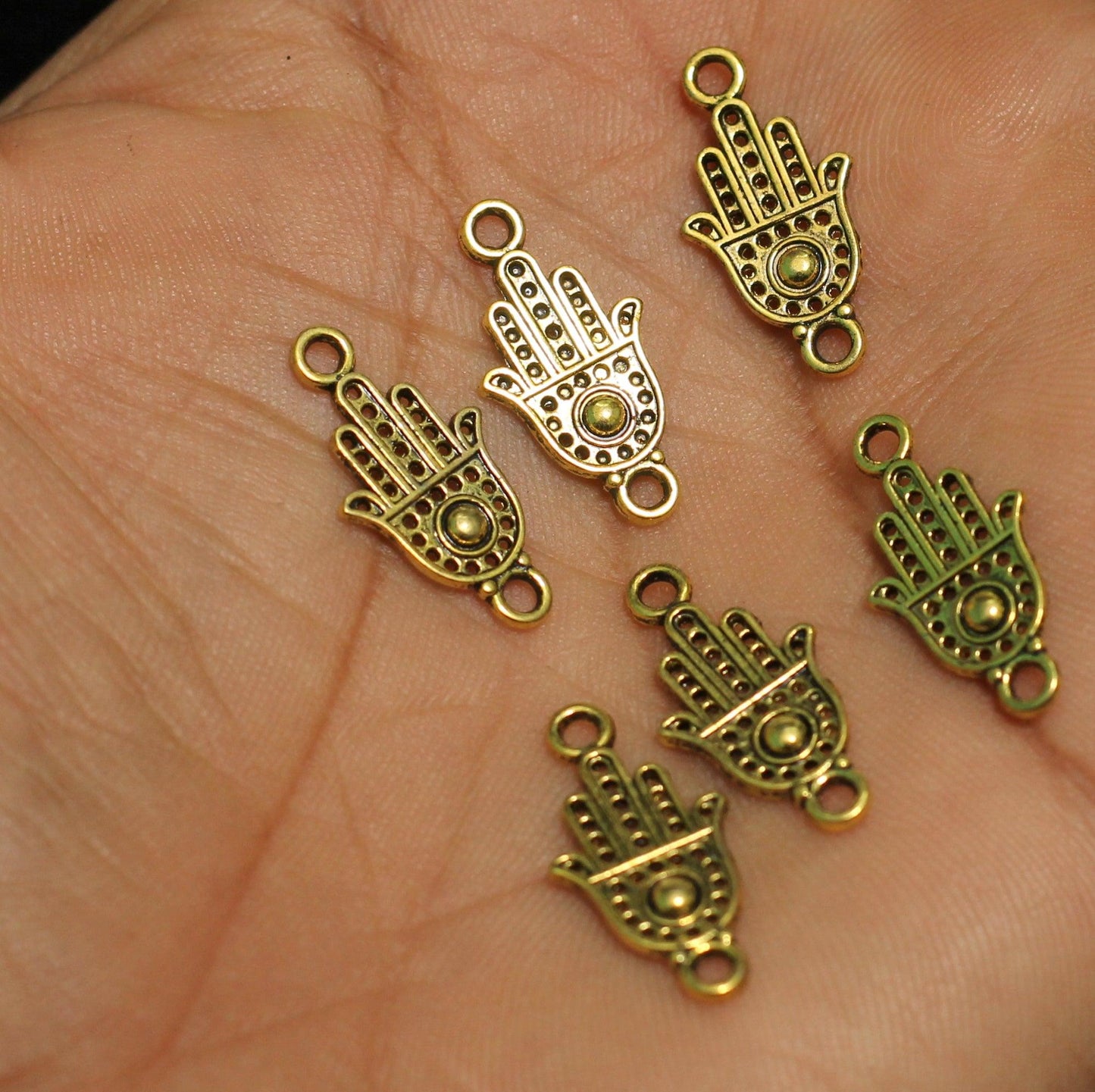 German Silver Hamsa hand Charms Golden 20x9mm - Golden / German Silver / 25 Pcs [ Rs 5 / Piece ]
