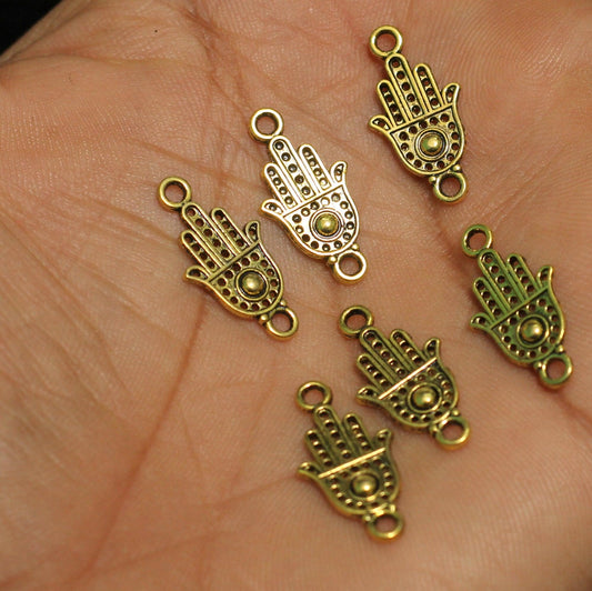 German Silver Hamsa hand Charms Golden 20x9mm - Golden / German Silver / 25 Pcs [ Rs 5 / Piece ]